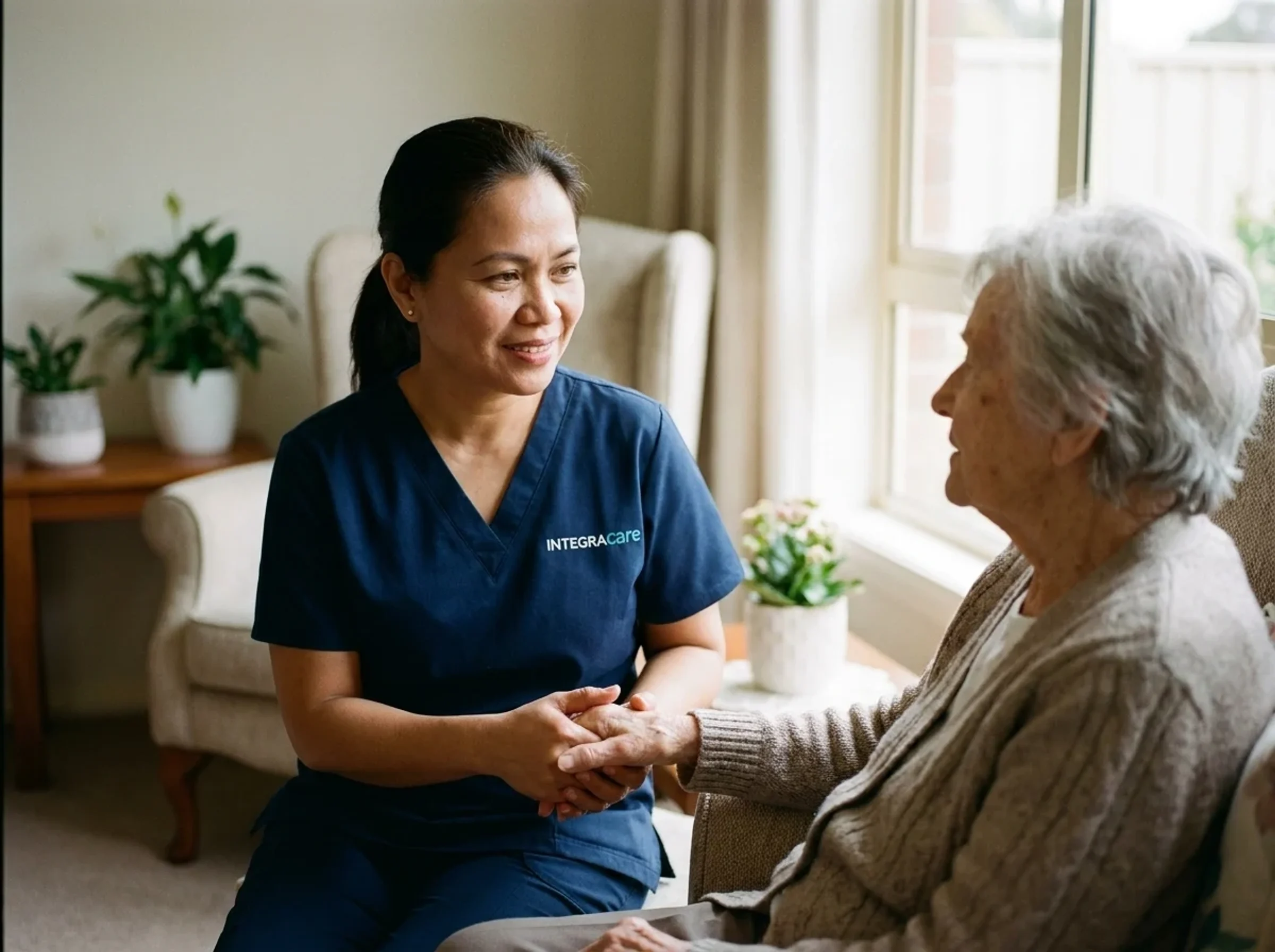 Caregiver holding the hands of an older adult client